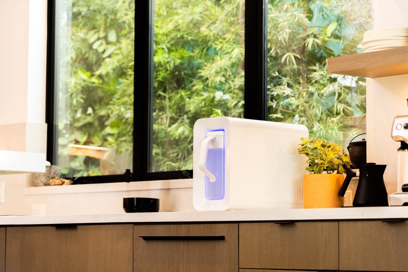 A Spout water machine on a sunlit kitchen counter at home